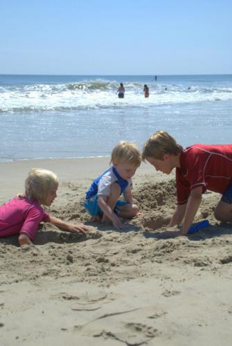 Youths building sand castles